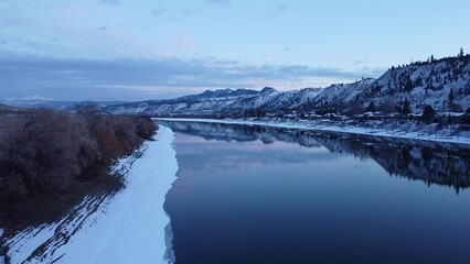 Sticker - Aerial of a scenic winter landscape with snowy mountains and shoreline of a frozen lake