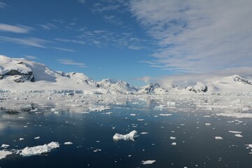 Wall Mural - Stunning view of a snow-covered landscape with a towering iceberg