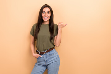 Sticker - Photo of ecstatic funny woman with straight hairdo dressed khaki t-shirt directing empty space discount isolated on beige color background