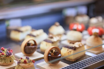 Poster - Selection of delicious pastries and desserts, arranged on dessert fridge display