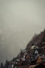 Poster - Picturesque winter scene in a rural town, with snow-capped mountains in the background