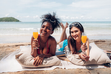 Wall Mural - Happy beauty woman in bikini sitting and drinking together on the beach having fun in a sunny day, Beach summer holiday sea people concept.