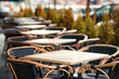 © Tricky Shark - Empty restaurant outdoor terrace with tables and chairs in autumn season. Cafe terrace on city street. Reastaurant tables waiting for visitors, empty seats, no people
