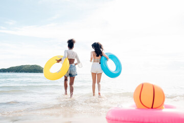 Wall Mural - Happy beauty woman in bikini walking and playing together on the beach having fun in a sunny day, Beach summer holiday sea people concept.