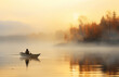 lonely fisherman on a boat on a foggy morning at dawn