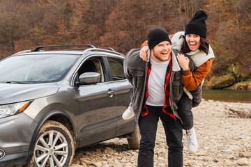 Sticker - happy couple piggyback car at rocky mountain beach