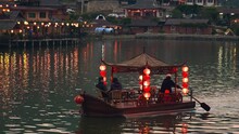 Tourists On An Asian Chinese Boat With Red Lanterns On A Lake In Thailand