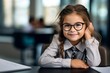 Portrait of diligent girl looking at camera at workplace with schoolboys on background