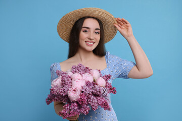 Poster - Beautiful woman with bouquet of spring flowers on light blue background