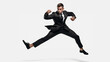 Businessman fighting and kicking while jumping