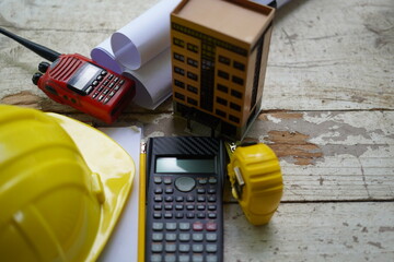 Set of professional construction tools and safety helmet on a work table. Top view. Tools. Various tools on a wooden table. engineering drawing Tools to work beyond architectural blueprints