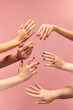 Beautiful female hands with different manicure, nail colors against pink background. Taking care. Concept of hand care, cosmetics and cosmetology, spa, natural beauty. Poster, ad