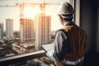 © ty - Engineer use digital tablet while standing in modern building tower and looking at the building under construction