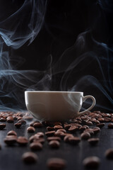 Canvas Print - White cup of hot espresso with steam and roasted coffee beans on dark black background