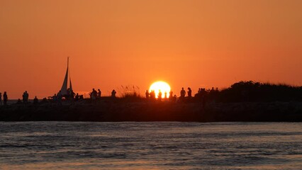 Canvas Print - Tourists enjoying sunset view on Nokomis jetty pier in Florida. Seaside summer activities