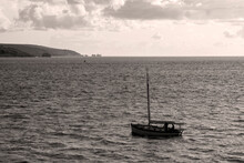 Sailing Boat Entering Harbour And Seascape In Black And White