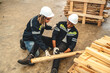 © chokniti - Warehouse worker man person has work related accident falls while trying to pick up wooden panel from the Shelf. colleagues call for help and medical assistance, injury and heal accident insurance