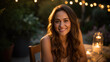 © MP Studio - Smiling woman sits at a table during an outdoor evening party in a home's backyard