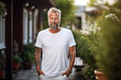 Mature bearded man on backyard of his house wearing plain white t-shirt mock up print design
