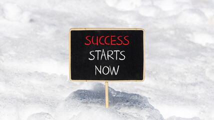Wall Mural - Success starts now symbol. Concept word Success starts now on beautiful black blackboard. White snow. Beautiful white snow background. Business motivational success starts now concept. Copy space.