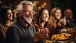 Happy Thanksgiving Day! Portrait of happy senior man clapping hands with friends during dinner party.