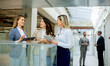 © BGStock72 - Three young business women with digital tablets discussing business ideas in the office hallway