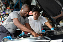 Mechanics Or Workers Checking And Fixing A Car In Garage