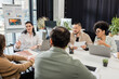 © LIGHTFIELD STUDIOS - happy multicultural business people discussing project and brainstorming on modern coworking office