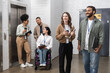 © LIGHTFIELD STUDIOS - inclusion and diversity, multiethnic creative team standing together neat office elevators in hall
