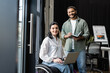 © LIGHTFIELD STUDIOS - three interracial businesswomen, disabled woman in wheelchair working with female team in office