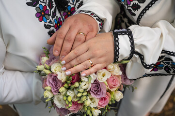 Wall Mural - close-up view of a young couple holding hands in embroidered traditional Ukrainian clothes