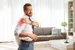 © Ljupco Smokovski - Man in a living room with shoulder pain