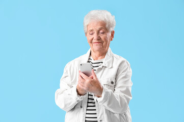 Sticker - Senior woman using mobile phone on blue background