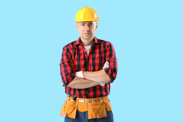 Poster - Mature worker on blue background. Labor Day celebration