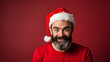© Moon Project - Christmas with bearded, cheerful and charismatic man with red cap. Reddish background.