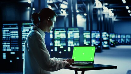 Poster - it consultant running code on chroma key laptop, troubleshooting data center equipment. cloud comput