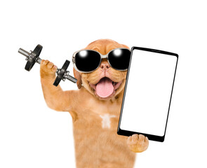 Aufkleber - Happy Mastiff puppy wearing sunglasses lifts dumbbells and holds big smartphone with empty screen in it paw . isolated on white background