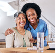 © Phindulo T/peopleimages.com - Portrait, smile and assisted living caregiver with an old woman in the living room of a home together. Healthcare, support or community with a happy nurse or volunteer and senior patient in a house