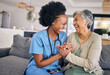Smile, funny and assisted living caregiver with an old woman in her home during retirement together. Healthcare, support and a happy nurse or volunteer laughing with a senior patient on the sofa