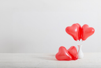 Wall Mural - heart shaped red balloons on white background