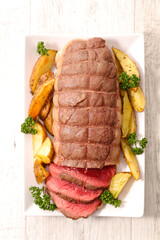 Wall Mural - roast beef sliced with fried potatoes