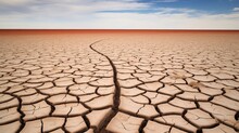 Drought Desolation: A Cracked, Dry Lake Bed In A Barren Landscape