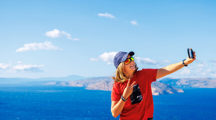 Teenager taking selfie in summer vacation- Croatia, adriatic sea and islands