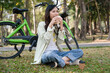 © MIND AND I - Young woman eating meal at park.
