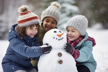 Multiethnic Children Building Snowman At The Park In Winter