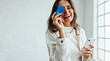 © (JLco) Julia Amaral - Online banking for business professionals: Happy business woman holding a credit card and a mobile phone