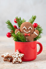 Wall Mural - Christmas gingerbread man cookie in red cup. Christmas card