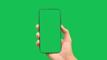 Hands holding smartphone with green screen in green background vertical green 