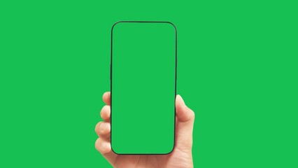 Hands holding smartphone with green screen in green background vertical green 