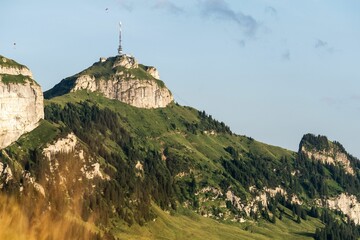 Wall Mural - Stunning aerial view of a rural mountain featuring an antenna atop its peak